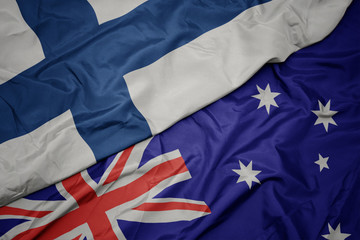 Fototapeta premium waving colorful flag of australia and national flag of finland.