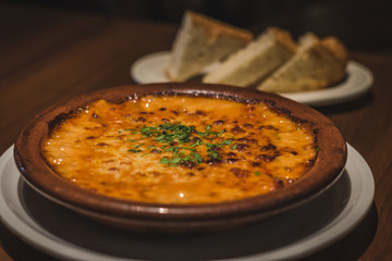 Creamy Tokyo Style Lasagna served in a brown china bowl with bread