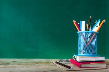 Back to school concept. colored pencil, and supplies  on wooden table