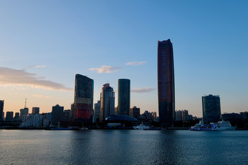 Fototapeta na wymiar sunrise of the North Bund in Shanghai. New area of commercial and trade center. Skyscraper on the bank of Huangpu River. Transtalation of words on building is Magnolia Plaza welcome you