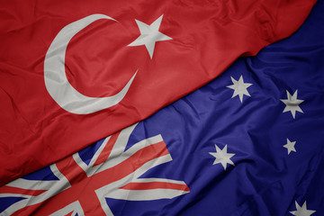 waving colorful flag of australia and national flag of turkey. © luzitanija