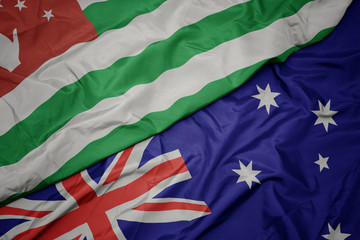 waving colorful flag of australia and national flag of abkhazia.