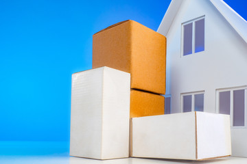 Parcels are at the house. Postage to the door. Parcel delivery company. Delivery of goods concept. Delivery of the order from the online store. Pile of stacked cardboard boxes with furniture.