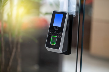 Facial recognition and fingerprints scanner machine for access door security and for records time attendance. Close up and selective Focus.