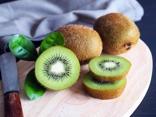 Slice of fresh kiwi fruit  on wooden background.