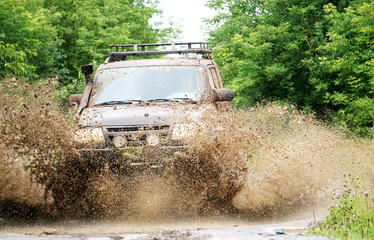 off-road car driving through a puddle, a lot of spray, dirt © Екатерина Ваулина