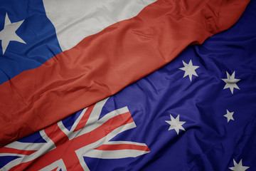 waving colorful flag of australia and national flag of chile.