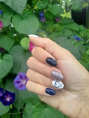  Manicure in black and white color with a heart on a nameless in a romantic style. Hand nails