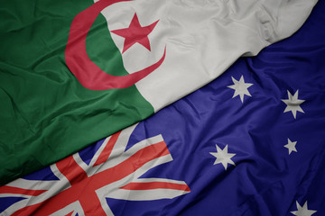 waving colorful flag of australia and national flag of algeria.