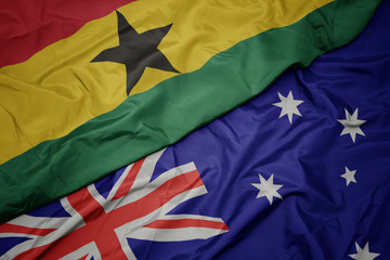 waving colorful flag of australia and national flag of ghana.
