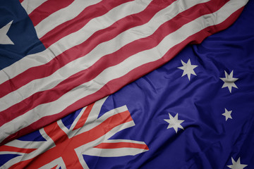 waving colorful flag of australia and national flag of liberia.