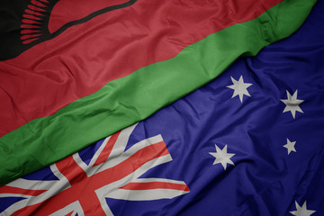 waving colorful flag of australia and national flag of malawi.