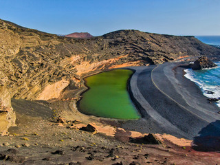 El charco de los Clicos, A small lagoon of soft green color at the bottom of the volcanic ash beach...