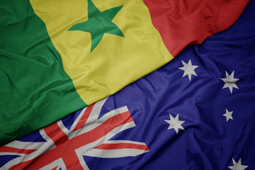 waving colorful flag of australia and national flag of senegal.