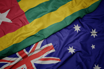 waving colorful flag of australia and national flag of togo.