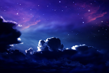 dark cloudy night sky with stars and nebulae