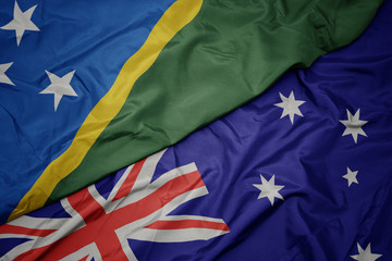 waving colorful flag of australia and national flag of Solomon Islands.