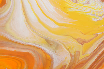 photography of abstract marbleized effect background. orange, gold, yellow and white creative colors. Beautiful paint.