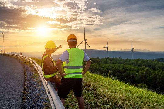 Two engineers consulted to fix and repair wind turbines to generate electricity with natural energy.