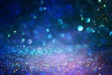 blackground of abstract glitter lights. blue, gold and black. de focused