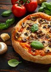 Hot Mushroom Pizza with basil, tomatoes, mozzarella and parmesan cheese on wooden table. ready to eat. vegetarian food