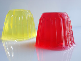 sweet jelly puddings strawberry and lemon flavor over white background