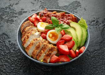 Chicken Cobb salad with strawberries, bacon, avocado and boiled eggs