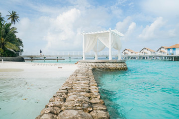 White arch with Beautiful Landscape of Tropical beach summer at resort hotel and spa, Maldives island with sea and sky tranquil for holiday vacation