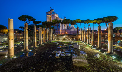 Vittorio Emanuele II monument at night, as seen from the Basilica Ulpia ruins, in Rome, Italy.