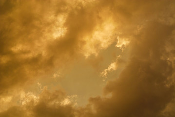 Wonderful sunset sky with golden clouds as background