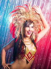 Carnival, dancer and holiday concept - Beauty brunette woman in cabaret suit and headdress with natural feathers and rhinestones.