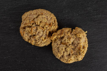 Group of two whole oat crumble biscuit flatlay on grey stone