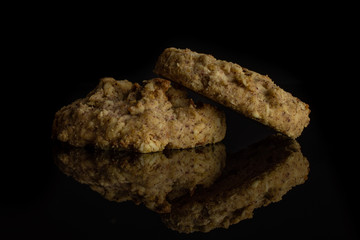 Group of two whole oat crumble biscuit isolated on black glass