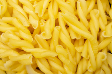Lot of whole raw pasta gemelli macro flatlay isolated