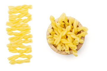 Lot of whole raw pasta gemelli in line in wooden bowl flatlay isolated on white background