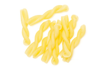 Lot of whole raw pasta gemelli flatlay isolated on white background