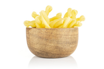 Lot of whole raw pasta gemelli in wooden bowl isolated on white background