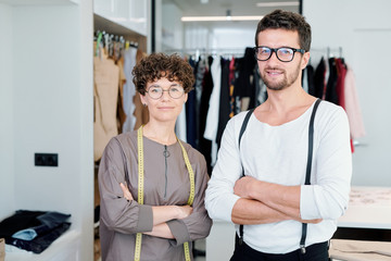Obraz premium Two young confident fashion designers and tailors with crossed arms