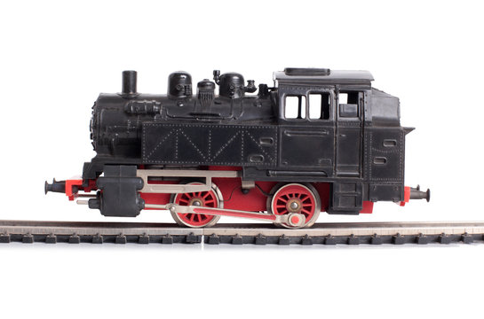 Steam train model on rails on a white background