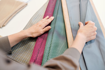 Female designer looking through textiles for new collection