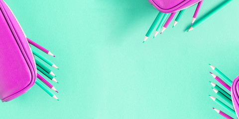 Back to school concept. Purple school accessories on mint background. Flat lay, top view, copy space