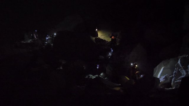 Tourists descend by the light of lanterns into the crater of a volcano Ijen in Java island, Indonesia