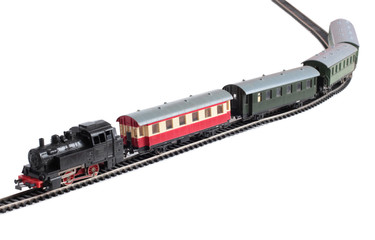 Model of a steam locomotive and passenger cars on rails on a white background