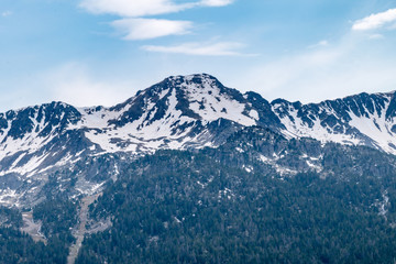View of mountains tops covered in snow in Andorra.