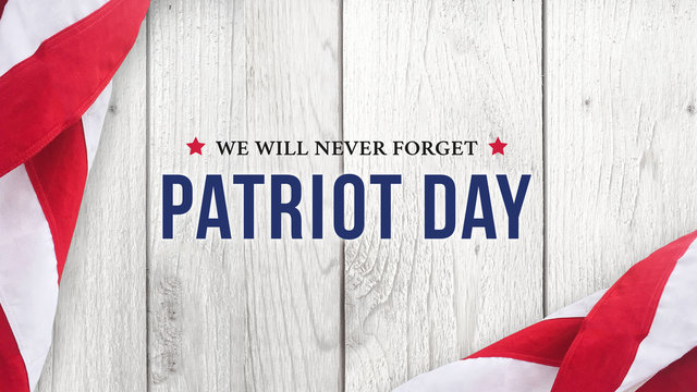 Patriot Day - We Will Never Forget Text Over White Wood with Flags