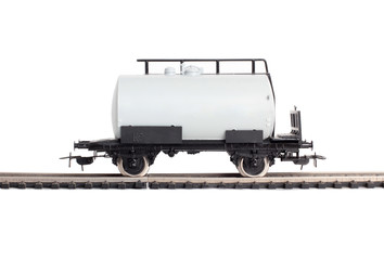 Model of a steam locomotive and cistern on rails on a white background
