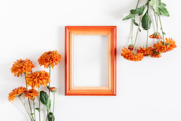Autumn creative composition. Photo frame, orange flowers on white background. Fall concept. Autumn background. Flat lay, top view, copy space