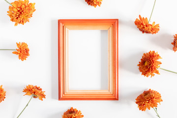 Autumn creative composition. Photo frame, orange flowers on white background. Fall concept. Autumn background. Flat lay, top view, copy space