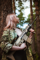 Beautiful portrait of a girl holding a gun