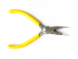 Small crooked pliers with bright yellow handles for a hobby isolated object on a white background.